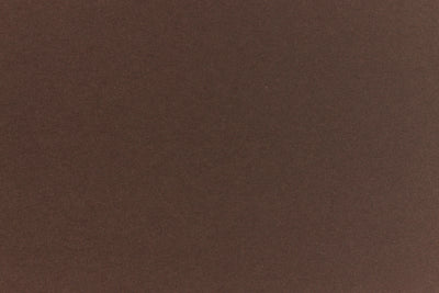 A deep and dark brown-black paper viewed in close detail. 